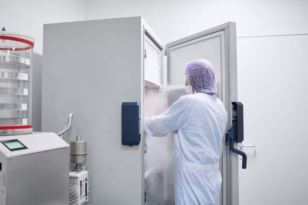 Staff storing medicines in medical fridge